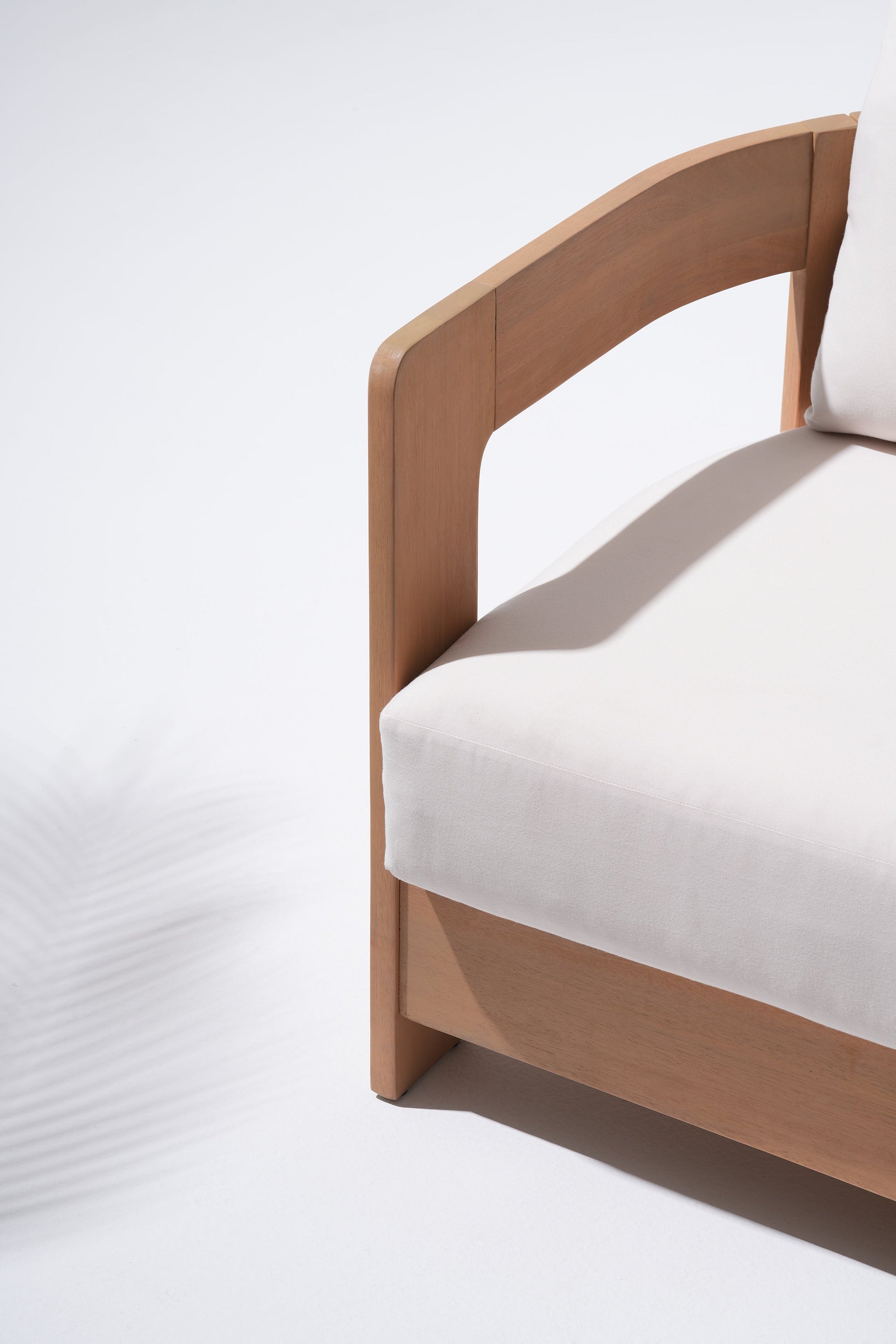 Wooden armrest with white cushion detail