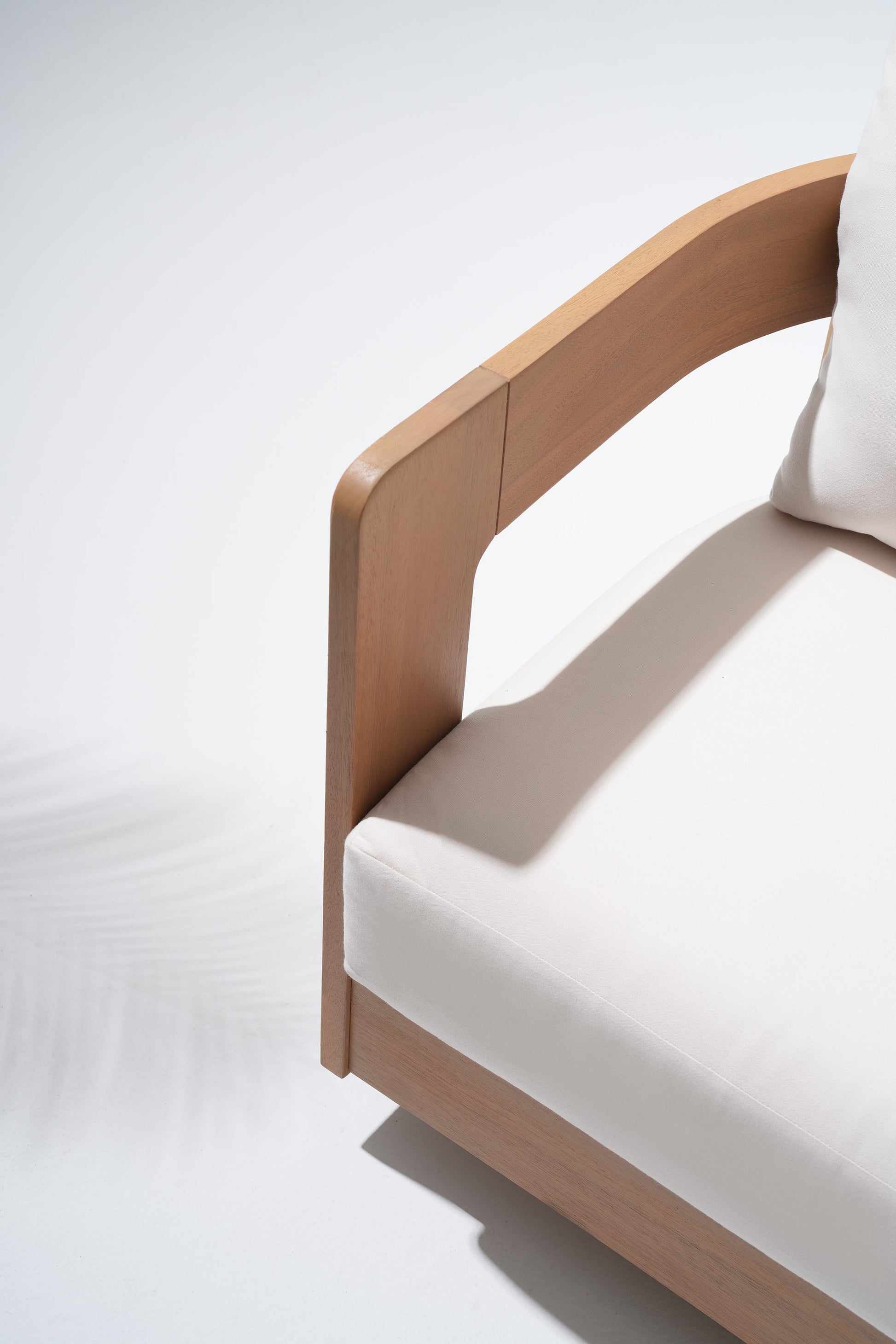 Wooden armchair with white cushion detail