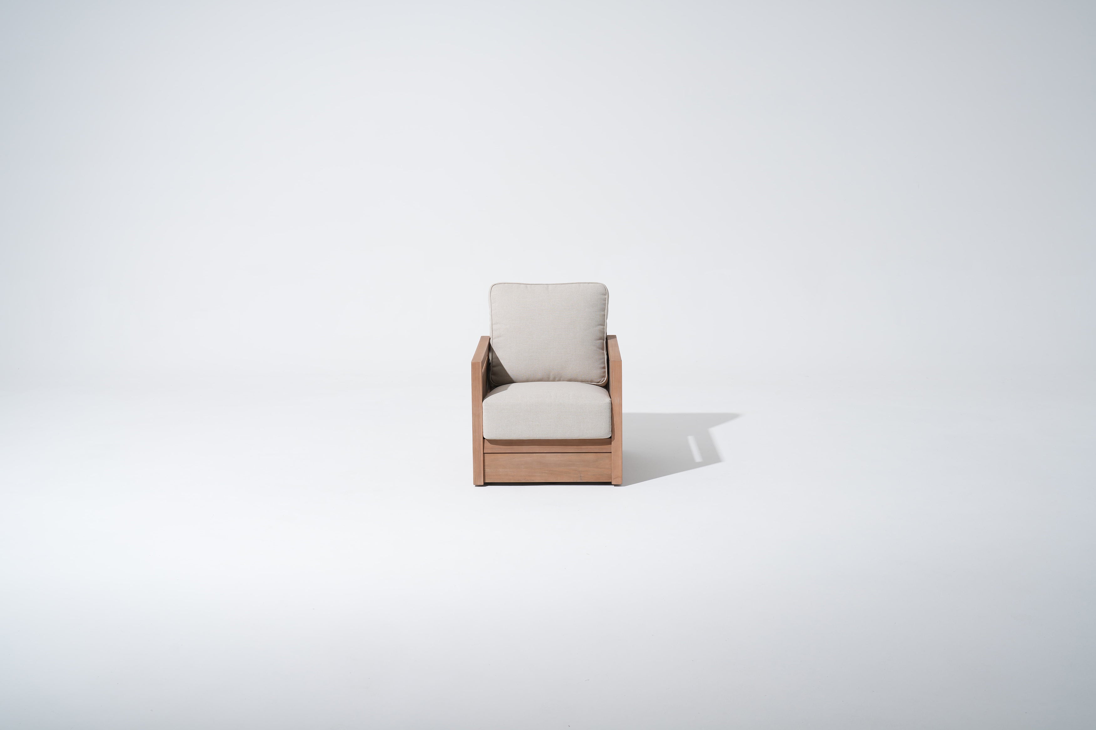 Modern armchair with wooden frame and beige cushion