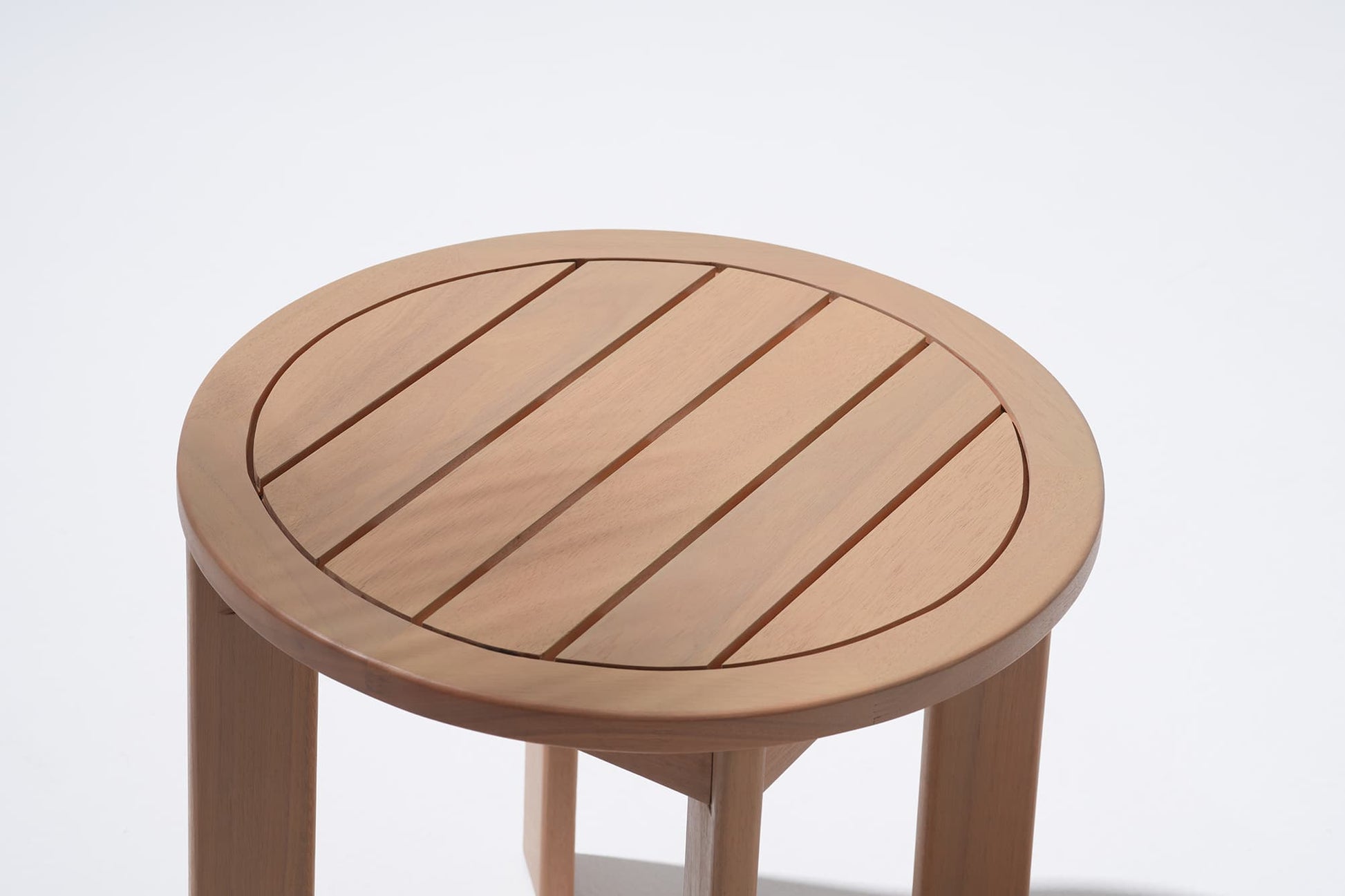Wooden round coffee table with a slatted design