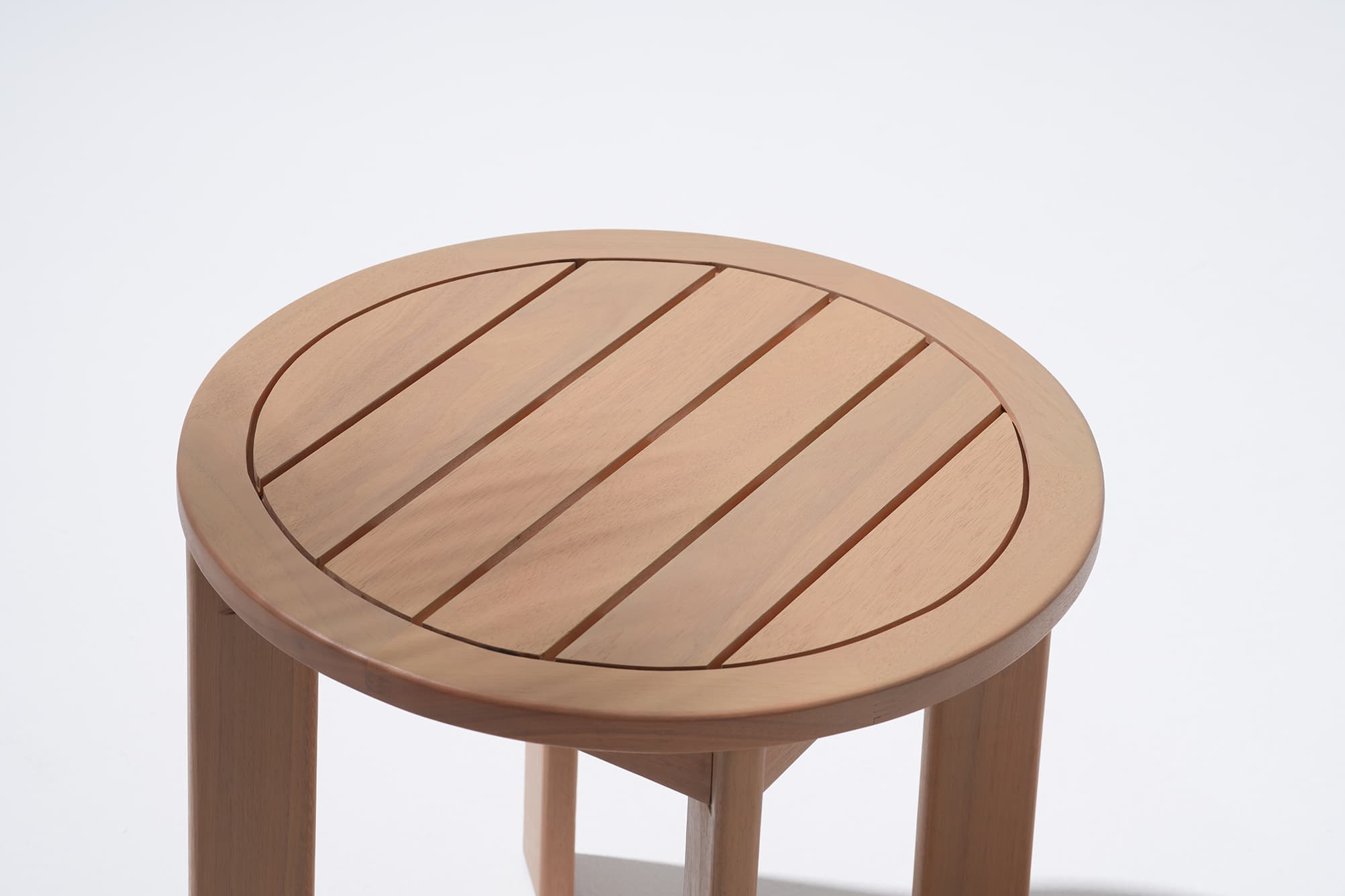 Wooden round coffee table with a slatted design