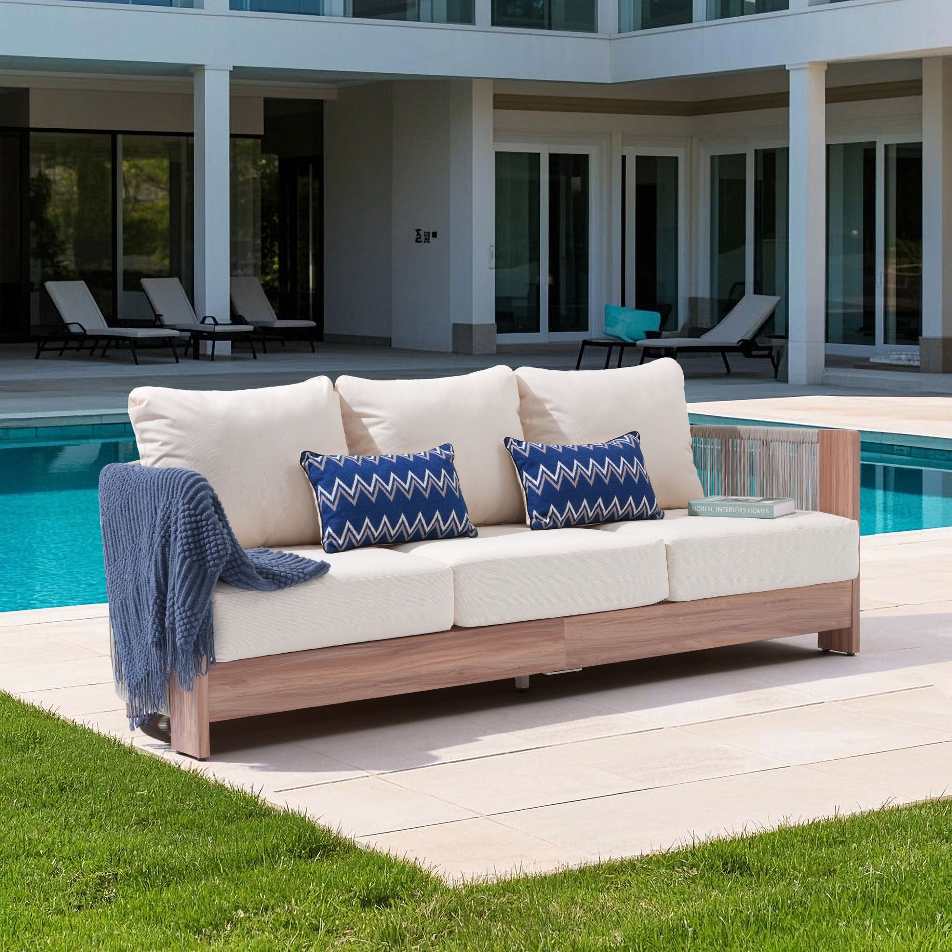 Outdoor 3-seat sofa with thick cushions by a poolside, hand woven rope design