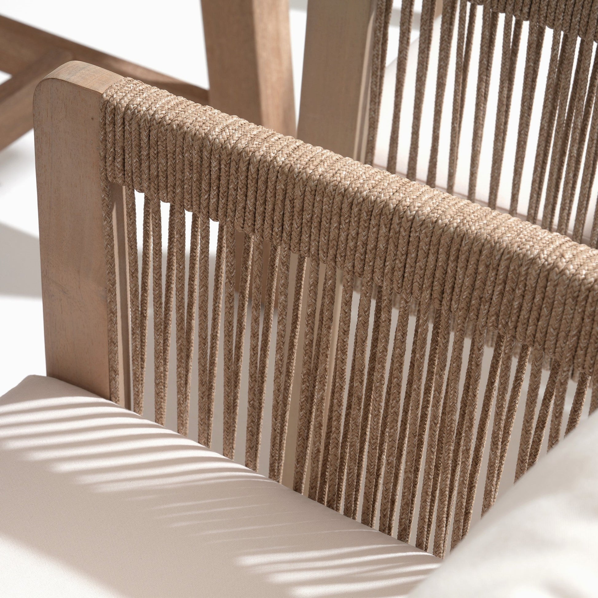 Close-up of a woven rope chair back with natural wood framerectnagular wood patio dining tabletop detail - Sunsitt Modern Premium Outdoor Patio Furniture