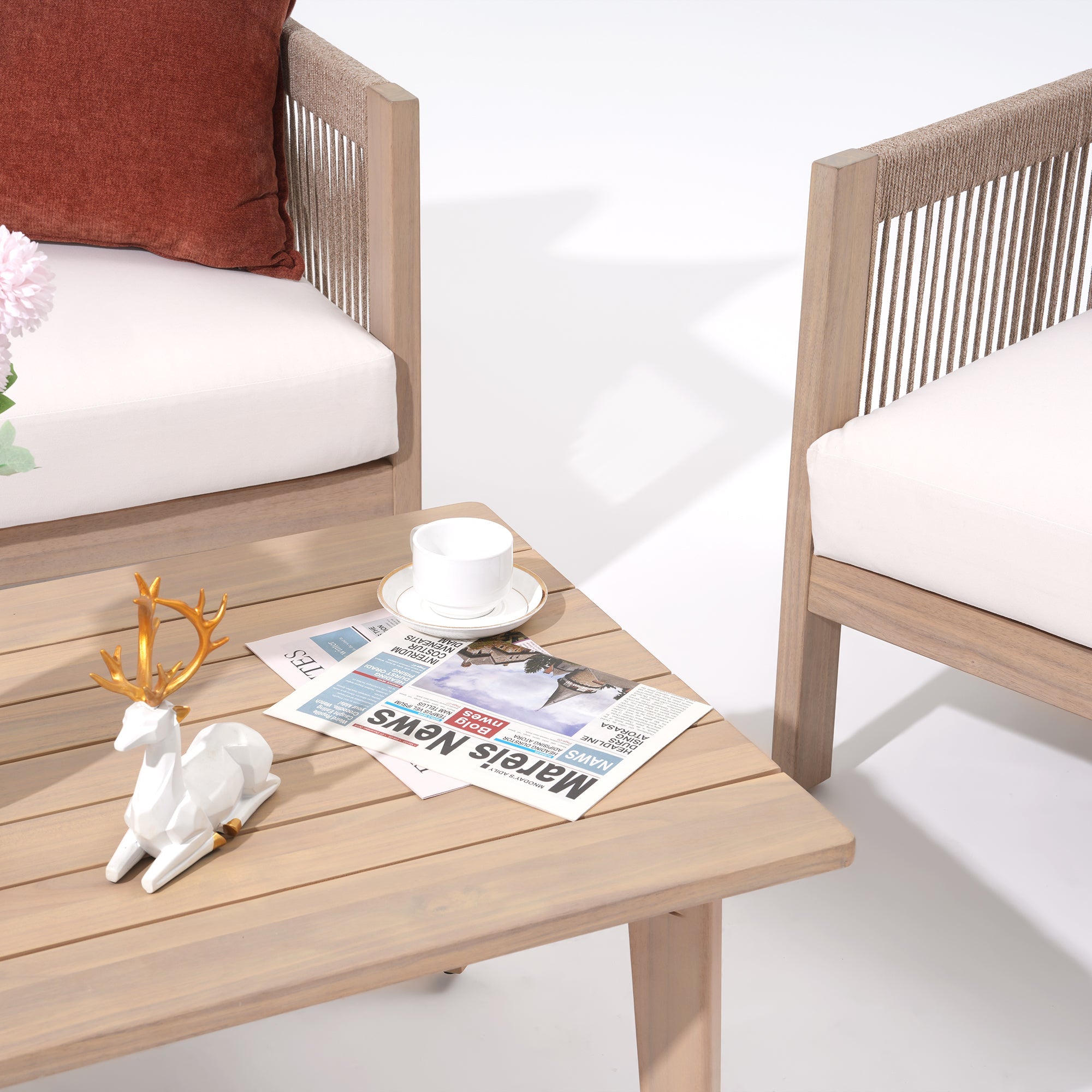 Wooden outdoor furniture set with a table, chairs, and decorative items on a white background