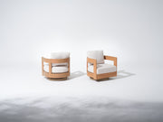 Two modern swivel chairs with wooden frames and white cushions