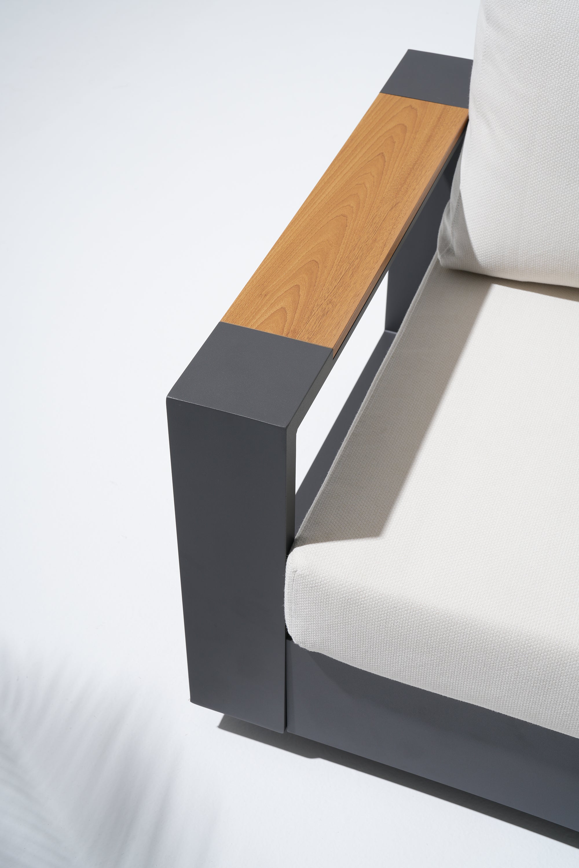 Modern swivel sofa with wooden armrest and gray frame details