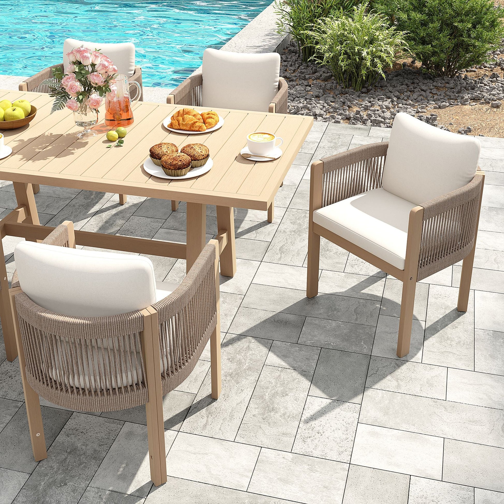 Outdoor patio set with table and chairs by a poolside, acacia wooden and hand woven rope design, white cushions