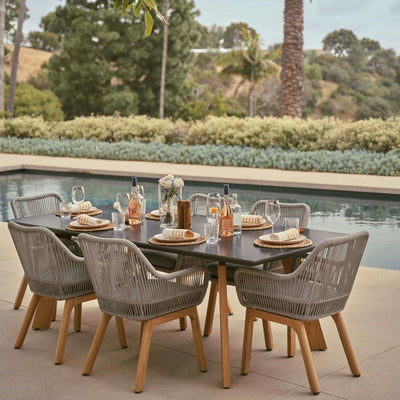 Natural - Dining Set For 8 People, 8 chairs, 1 dining table, teak leg, aluminum frame, grey cushions, sintered stone glasstabletop, classic and European design, in the garden, beside a pool.- Sunsitt Signature