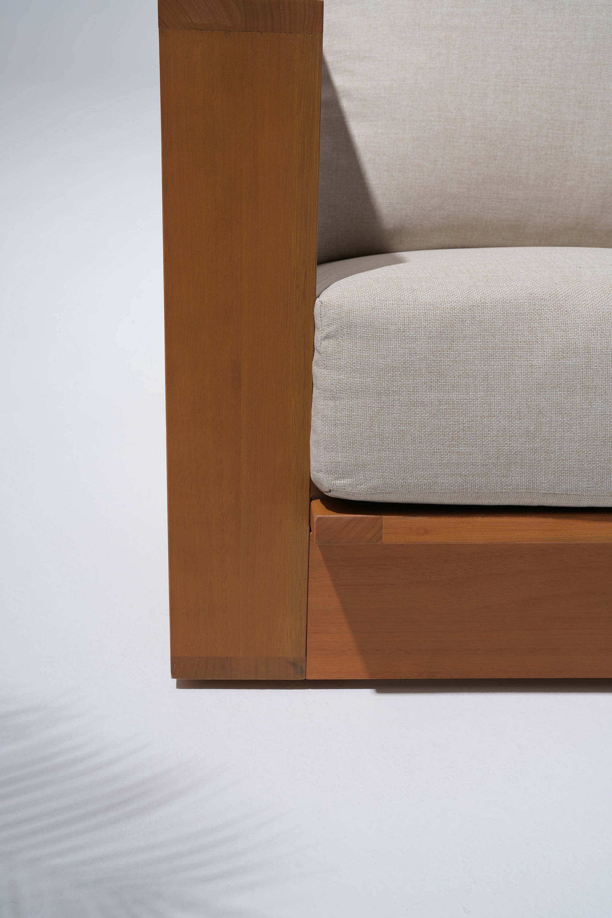 Drift outdoor couch with wooden frame and beige thick cushion details