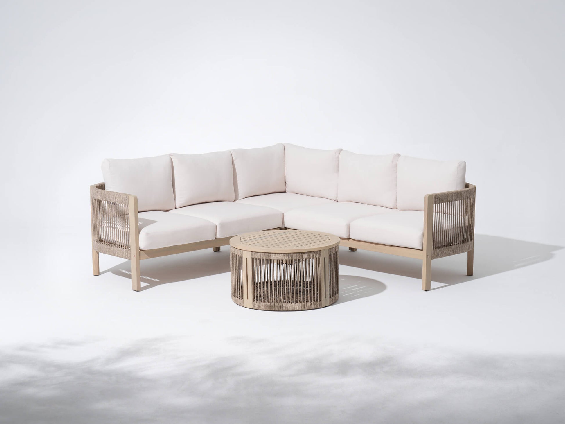 Foristern L-shaped outdoor sectional sofa with white cushions and a matching coffee table, wooden frame and rope design