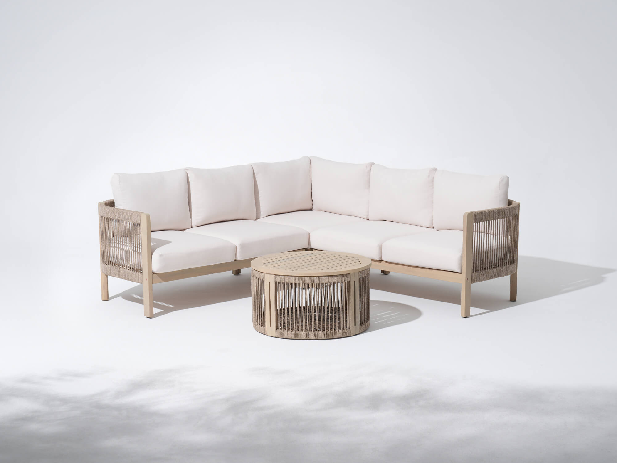 Foristern L-shaped outdoor sectional sofa with white cushions and a matching coffee table, wooden frame and rope design