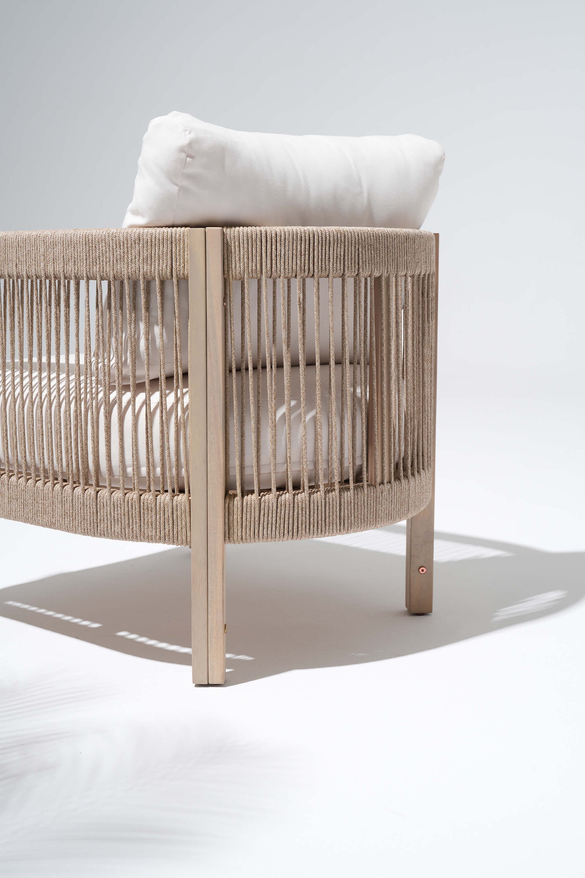Beige crib with a white pillow, woven rope backrest detail - Sunsitt’s Modern Premium Outdoor Furniture