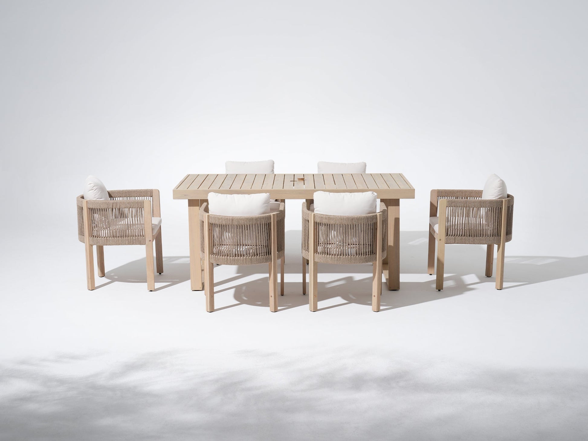 7-pc Outdoor furniture dining set with a rectangular table, with an umbrella hole and six rope chairs