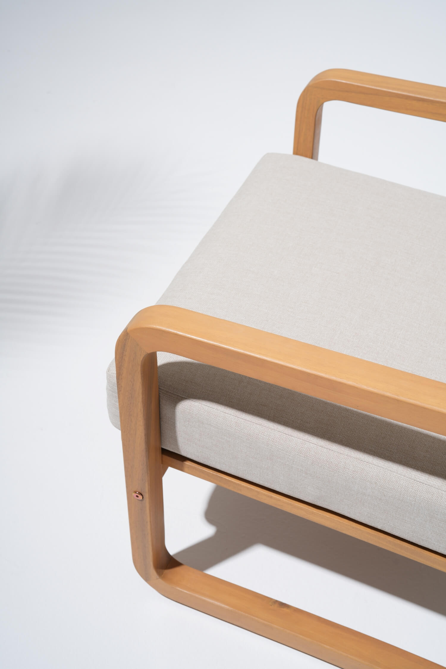 Noto lounge chair with wooden frame and beige cushion details