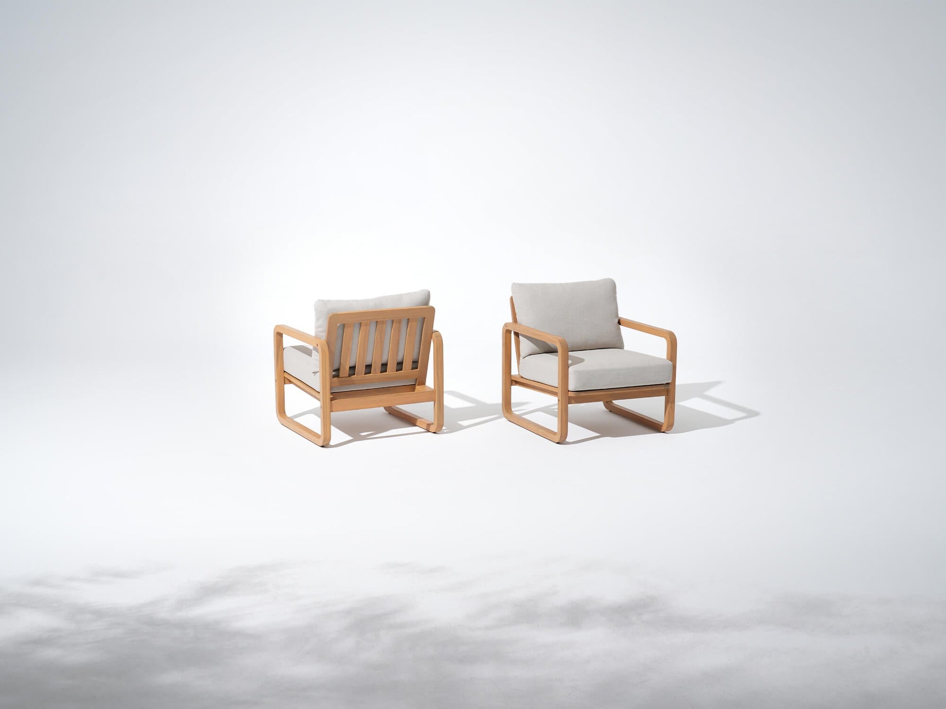 Two wooden lounge chairs with comf thick cushions