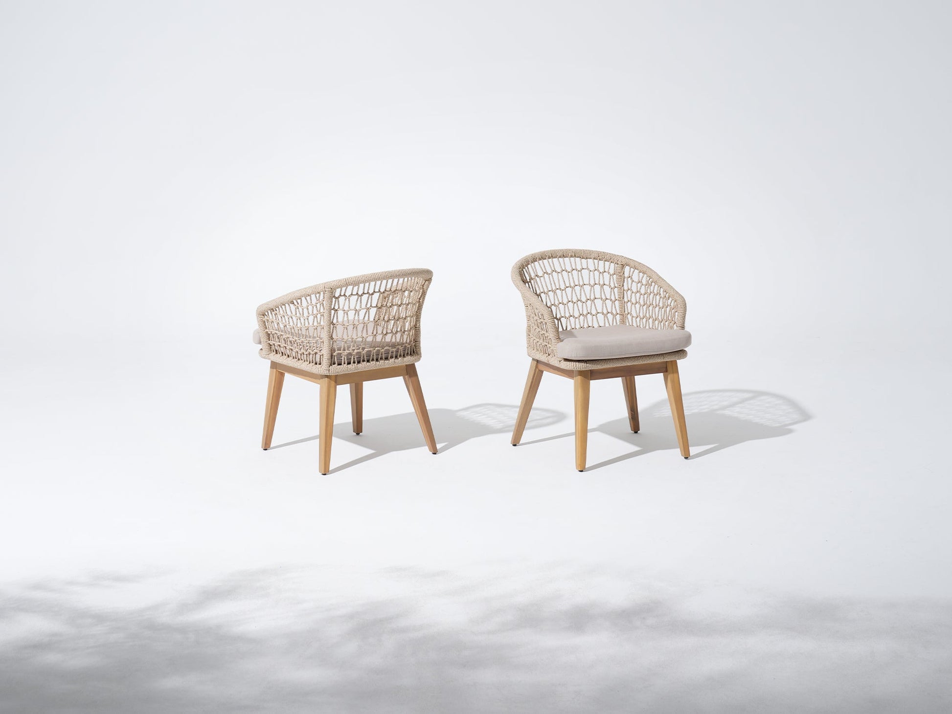 Two rope chairs with wooden frames