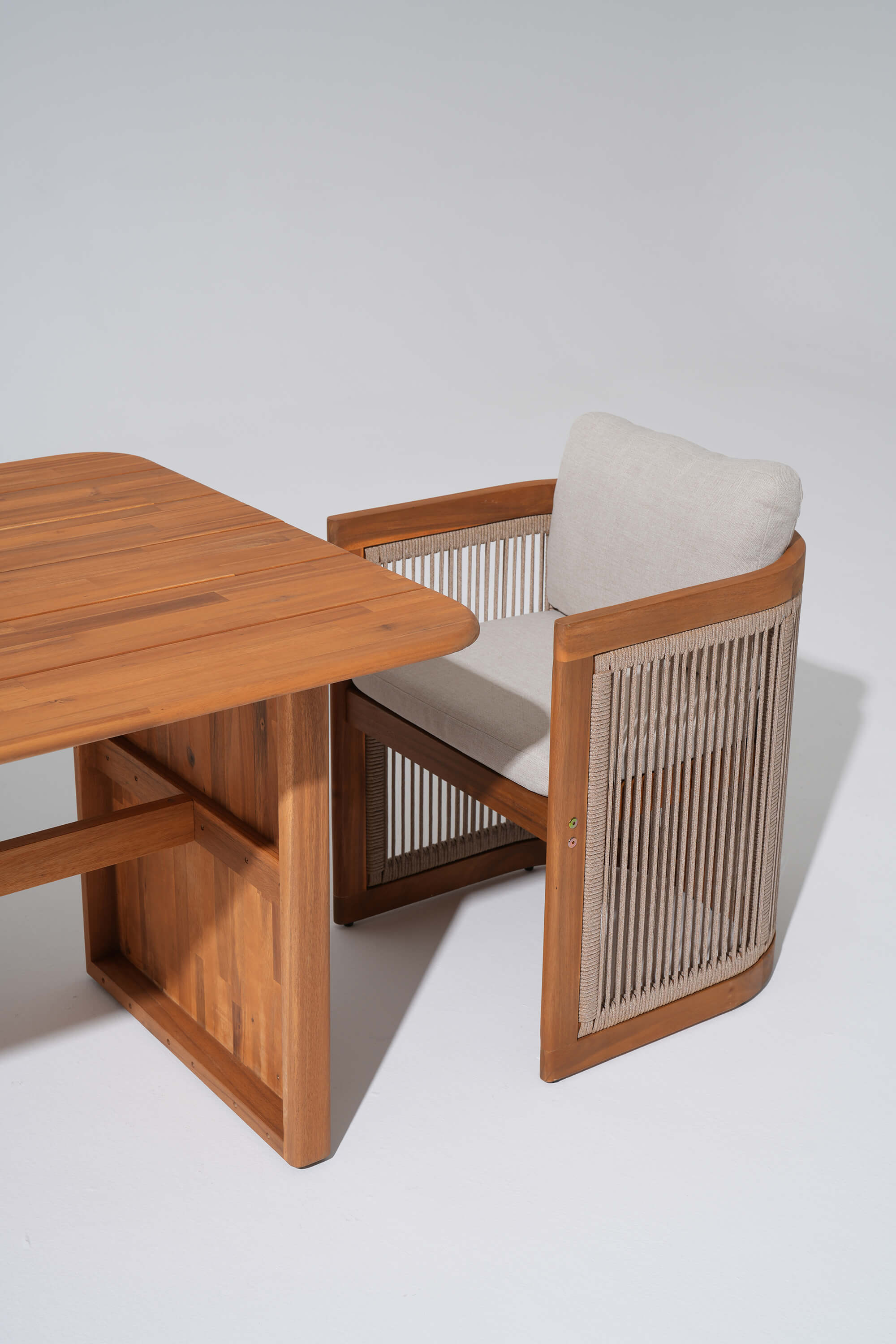 Wooden chair with woven rope backrest next to a wooden table- Sunsitt Modern Premium Patio Outdoor Furniture 