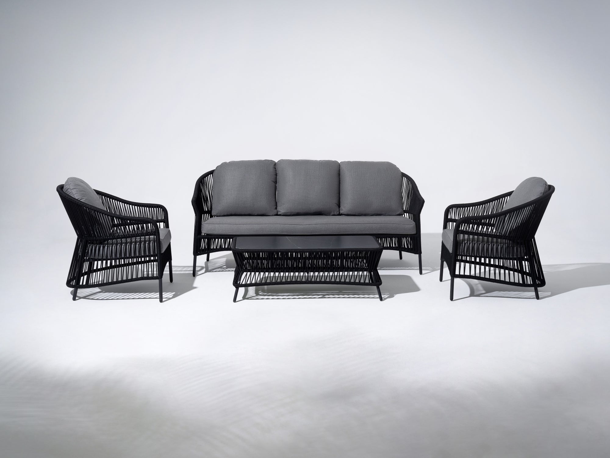 4-pcs Outdoor seating conversation set with gray seat cushions and back cushions, a 3-seat sofa, two single sofa armchairs with black rope design, a rectangular outdoor coffee table with black rope design and Sintered Stone Top Table - SUNSITT Premium Modern Outdoor Patio Furniture Set